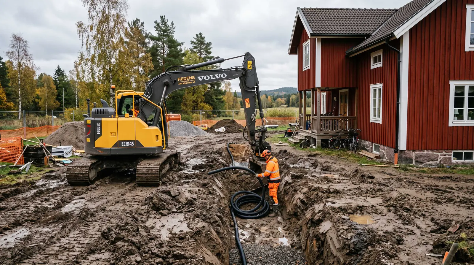 Grävmaskin och arbetare med dräneringsslang vid hus